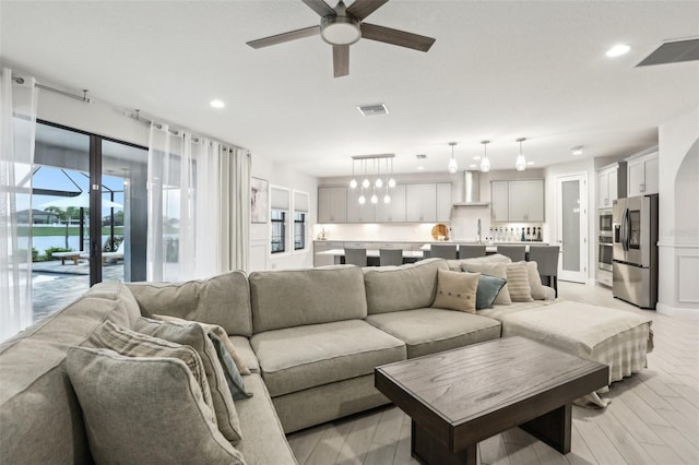13176 Twin Bridges Dr, Riverview, FL 33579 - living room with ceiling fan, recessed lighting, light wood-style floors, and a water view