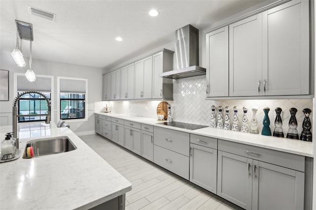 13176 Twin Bridges Dr, Riverview, FL 33579 - kitchen featuring wall chimney exhaust hood, a sink, gray cabinets, tasteful backsplash, and recessed lighting