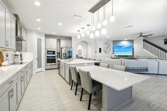 13176 Twin Bridges Dr, Riverview, FL 33579 - kitchen with appliances with stainless steel finishes, a breakfast bar, recessed lighting, a spacious island, and tasteful backsplash