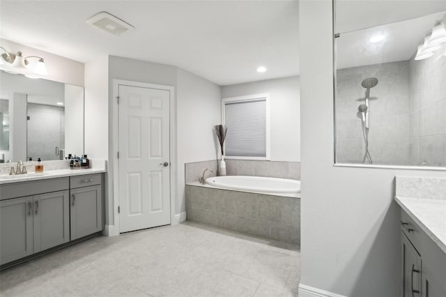 13176 Twin Bridges Dr, Riverview, FL 33579 - bathroom with vanity, a garden tub, a tile shower, tile patterned floors, and recessed lighting
