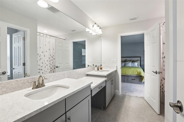 13176 Twin Bridges Dr, Riverview, FL 33579 - bathroom featuring double vanity, tile patterned floors, connected bathroom, and curtained shower