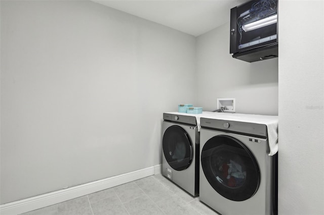 13176 Twin Bridges Dr, Riverview, FL 33579 - laundry room featuring washing machine and clothes dryer, light tile patterned flooring, and baseboards