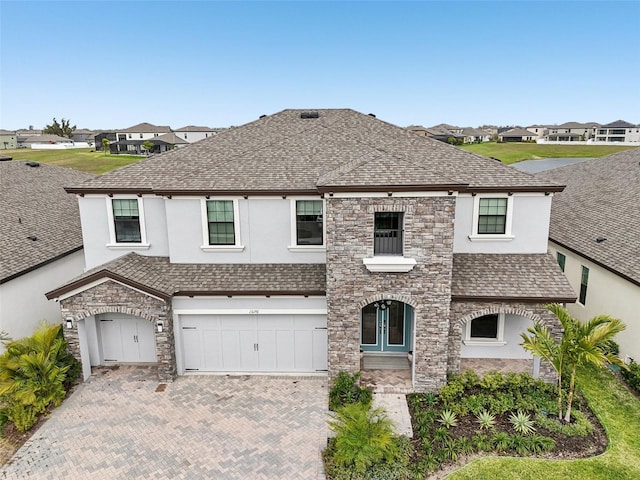 13176 Twin Bridges Dr, Riverview, FL 33579 - view of front of house with stucco siding, decorative driveway, a shingled roof, stone siding, and a residential view