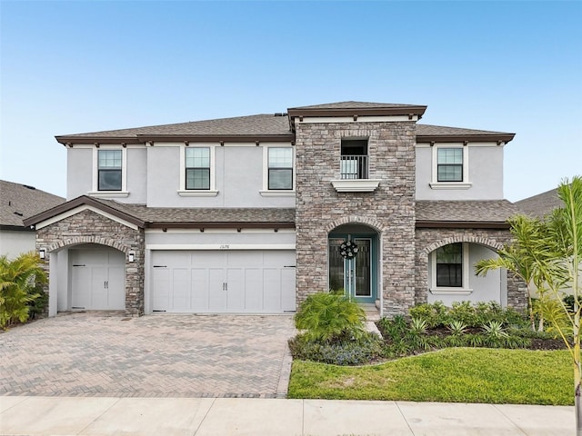13176 Twin Bridges Dr, Riverview, FL 33579 - view of front facade with stucco siding, a balcony, decorative driveway, and an attached garage