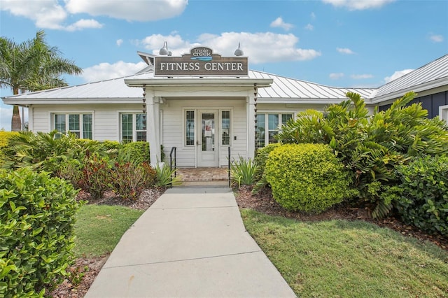 13176 Twin Bridges Dr, Riverview, FL 33579 - doorway to property featuring a standing seam roof, metal roof, and a yard
