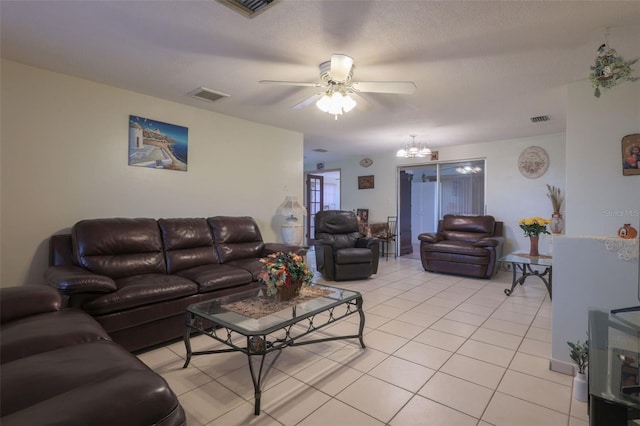 living area featuring visible vents, a textured ceiling, and light tile patterned floors