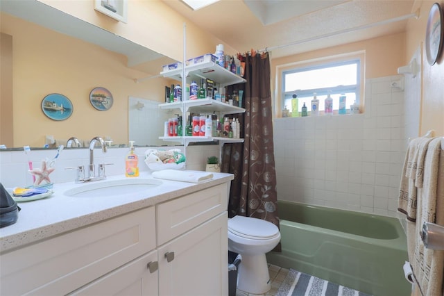 full bath featuring toilet, tile patterned flooring, shower / tub combo with curtain, and vanity