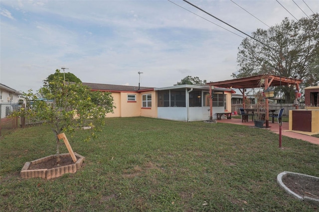 view of yard featuring a patio area, fence, and a sunroom