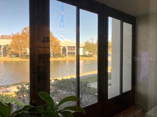 doorway to outside featuring a water view