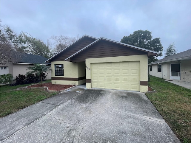 ranch-style home featuring a front lawn, concrete driveway, an attached garage, and stucco siding