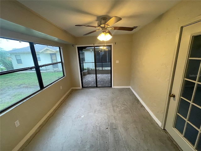 empty room with baseboards and a ceiling fan