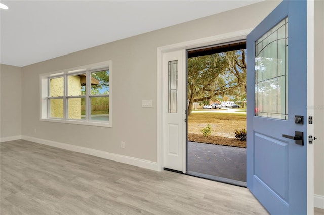 entryway featuring light wood-type flooring and baseboards