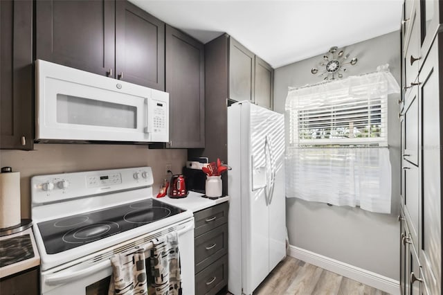 kitchen with white appliances, light wood-style flooring, and dark brown cabinetry