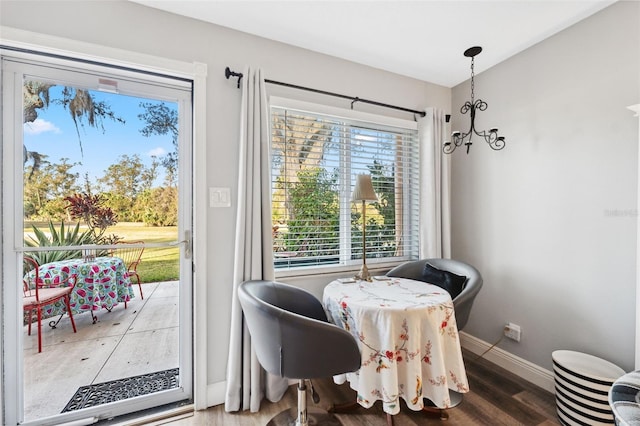 dining room featuring wood finished floors and baseboards