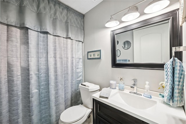 full bathroom with toilet and vanity