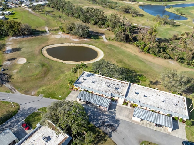 drone / aerial view with a water view and golf course view