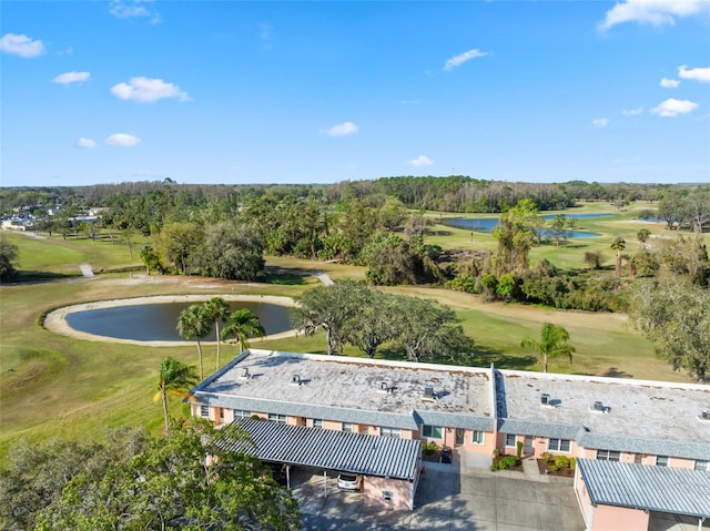 drone / aerial view with a water view and golf course view