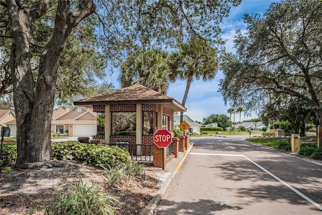 view of road featuring curbs, traffic signs, and a residential view