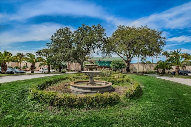 view of home's community featuring a yard and fence