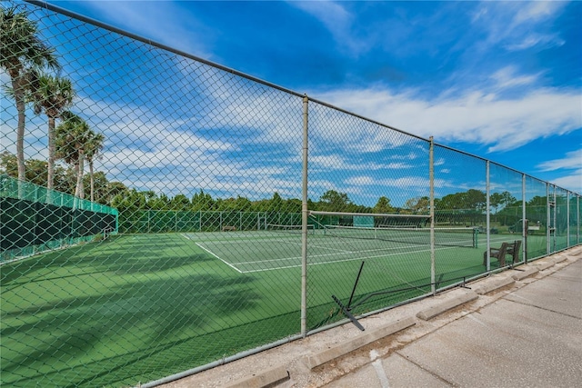 view of sport court featuring fence