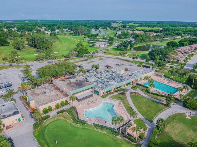 birds eye view of property featuring view of golf course and a water view