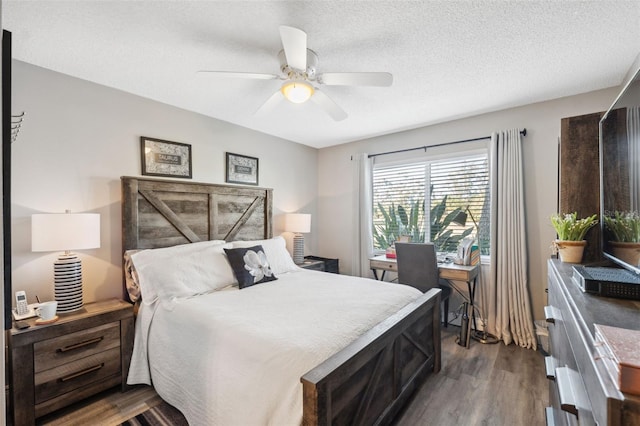 bedroom with dark wood-style floors, ceiling fan, and a textured ceiling