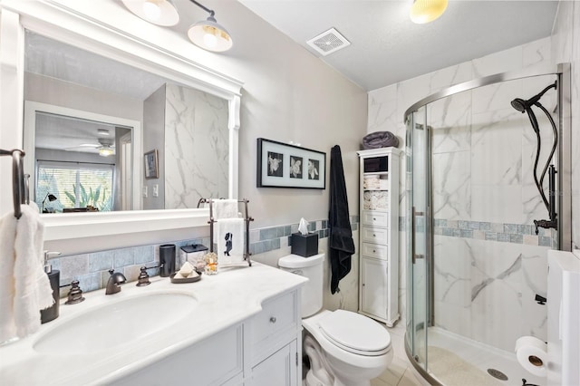 full bath featuring a stall shower, visible vents, toilet, vanity, and tile walls