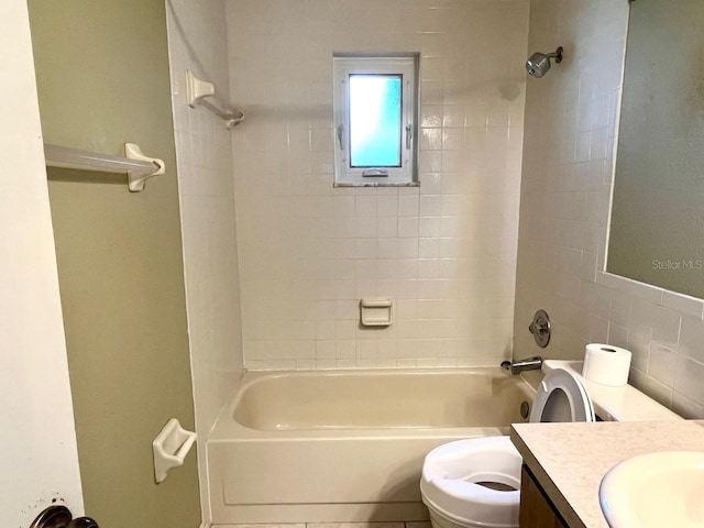 full bath with toilet, vanity, tile walls, and bathing tub / shower combination