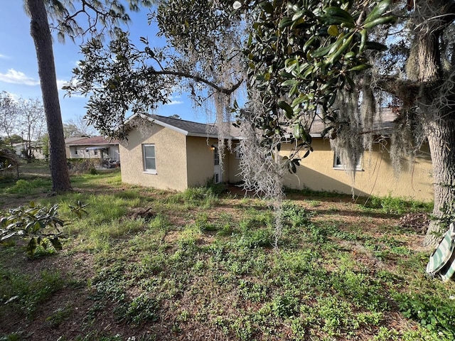 view of side of property featuring stucco siding