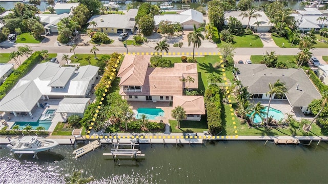 bird's eye view featuring a water view and a residential view