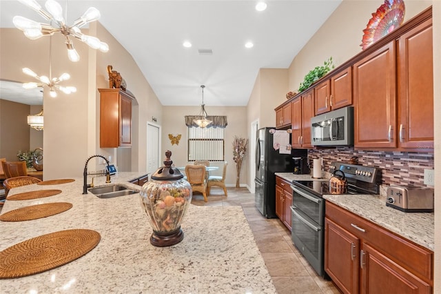 kitchen with visible vents, appliances with stainless steel finishes, a sink, an inviting chandelier, and backsplash