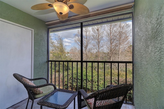 sunroom with plenty of natural light and a ceiling fan