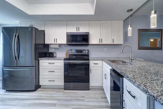 kitchen with white cabinets, stainless steel appliances, and a sink