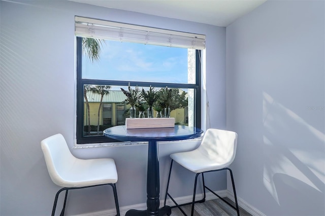 dining space with wood finished floors and baseboards