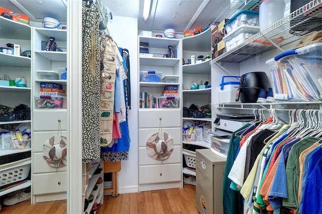 walk in closet featuring light wood finished floors