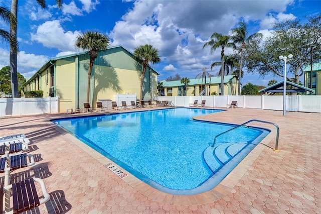 pool featuring a patio area and fence