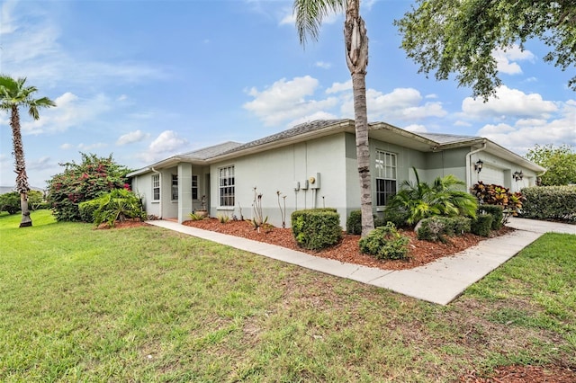 29312 Marker Loop, San Antonio, FL 33576 - view of front of home featuring an attached garage, stucco siding, and a front lawn