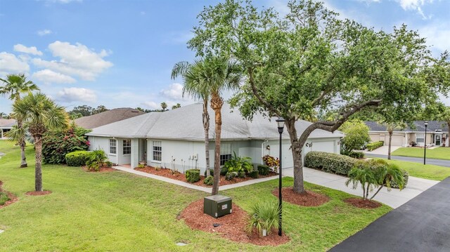29312 Marker Loop, San Antonio, FL 33576 - ranch-style house with concrete driveway, a garage, and a front lawn