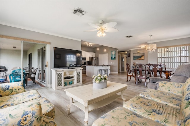 29312 Marker Loop, San Antonio, FL 33576 - living area with a ceiling fan, crown molding, a chandelier, and light wood finished floors