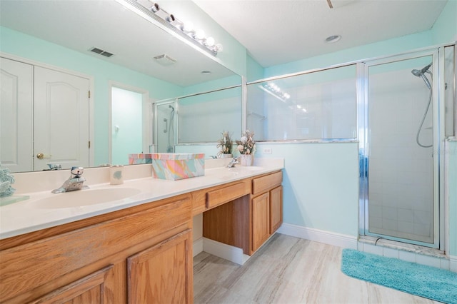 29312 Marker Loop, San Antonio, FL 33576 - full bath featuring double vanity, a stall shower, and wood finished floors