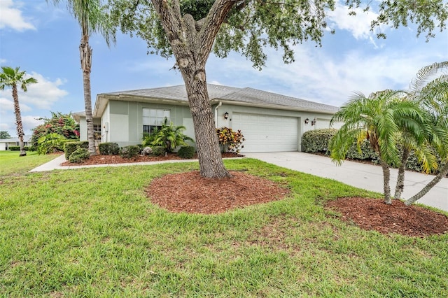 29312 Marker Loop, San Antonio, FL 33576 - view of front facade featuring stucco siding, an attached garage, driveway, and a front lawn