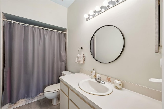 bathroom with toilet, vanity, and a shower with curtain