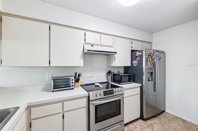 kitchen with under cabinet range hood, a sink, white cabinetry, stainless steel appliances, and light countertops