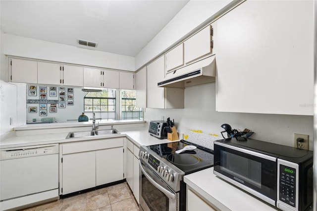 kitchen featuring visible vents, under cabinet range hood, light countertops, appliances with stainless steel finishes, and a sink