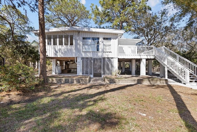 rear view of house with stairway and a deck