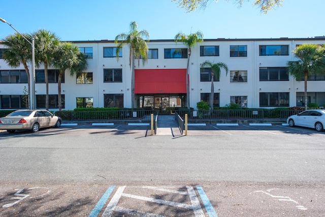 view of property featuring uncovered parking