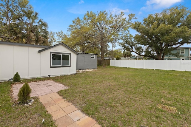 view of yard with a fenced backyard and an outdoor structure