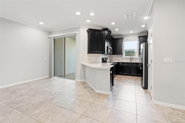 kitchen with visible vents, dark cabinets, stainless steel appliances, light countertops, and backsplash