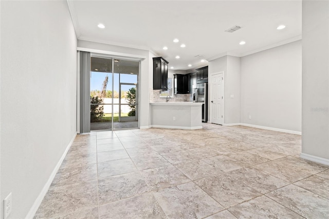 unfurnished living room with baseboards, crown molding, and recessed lighting