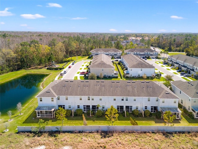 bird's eye view with a residential view, a water view, and a wooded view